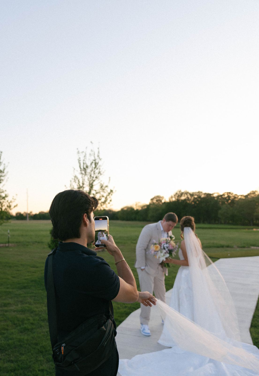 Jose filming a couple at golden hour
