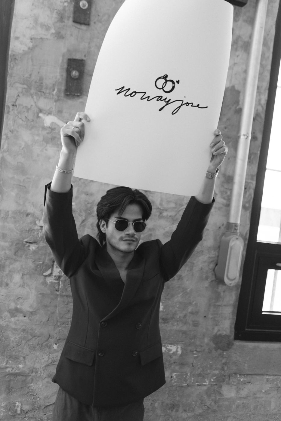 Jose holding the no way jose sign overhead, black and white